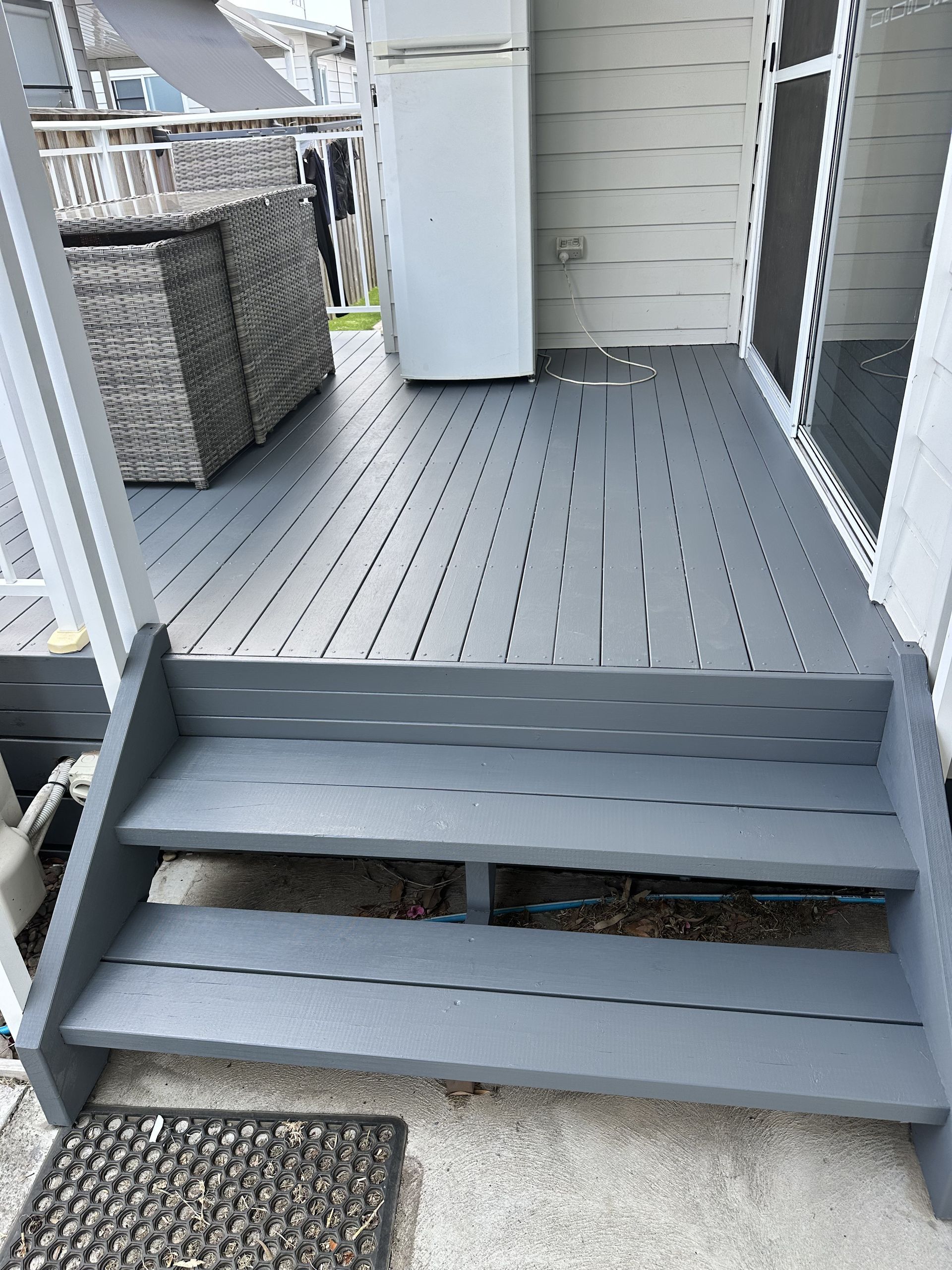 A Large House With A Gray Roof And A Lush Green Lawn — LMS Painting & Maintenance Pty Ltd In North Lambton, NSW