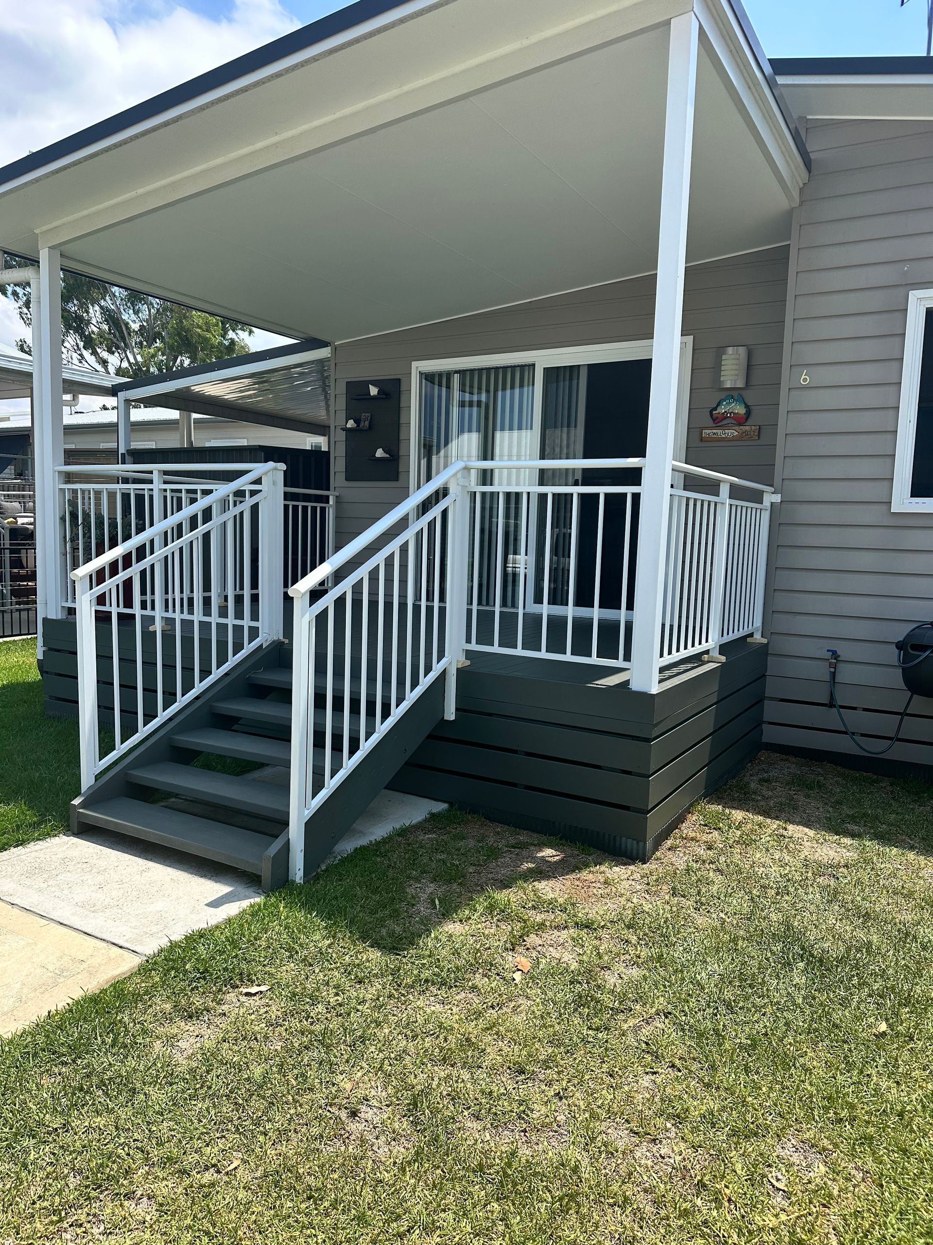 A house with a porch and stairs leading up to it — LMS Painting & Maintenance Pty Ltd In North Lambton, NSW
