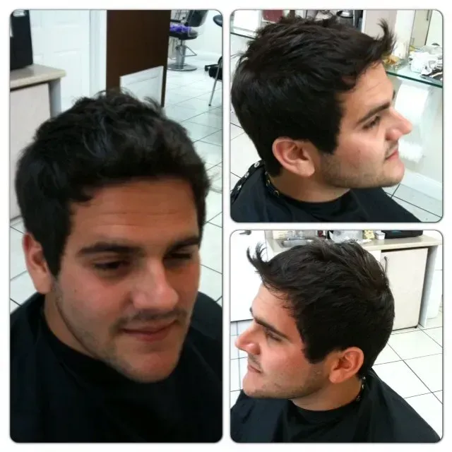 A man is getting his hair cut in a salon