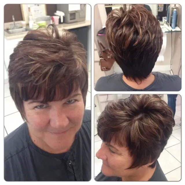 A woman with short brown hair is smiling for the camera