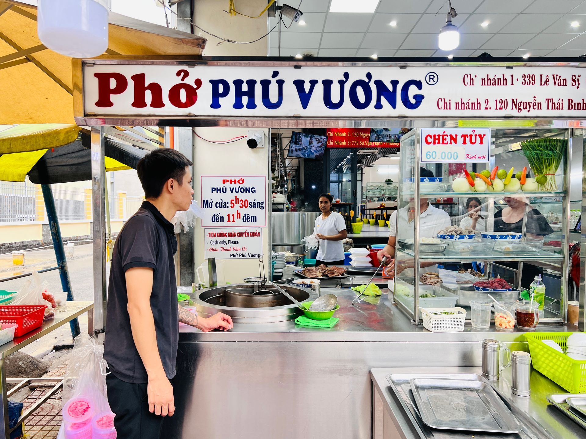 Saigons Best Pho Banner With Man At Counter