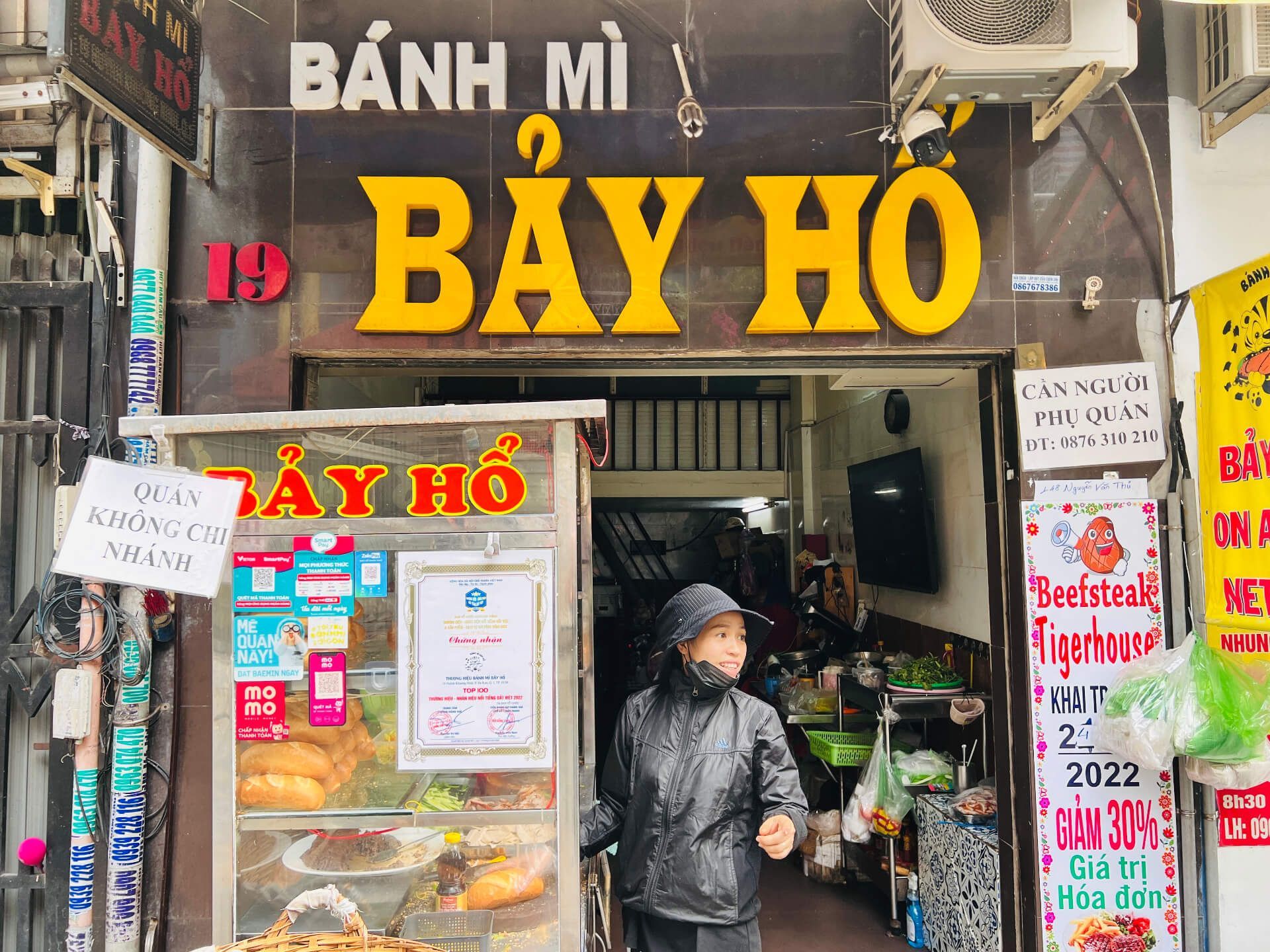 Woman making Banh Mi in Saigon.