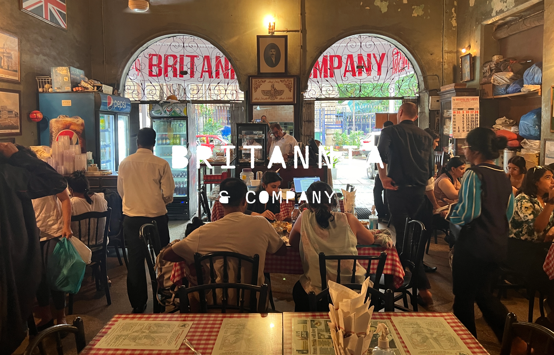 A restaurant with a sign on the wall that says exotic parsi and indian cuisine only cash.