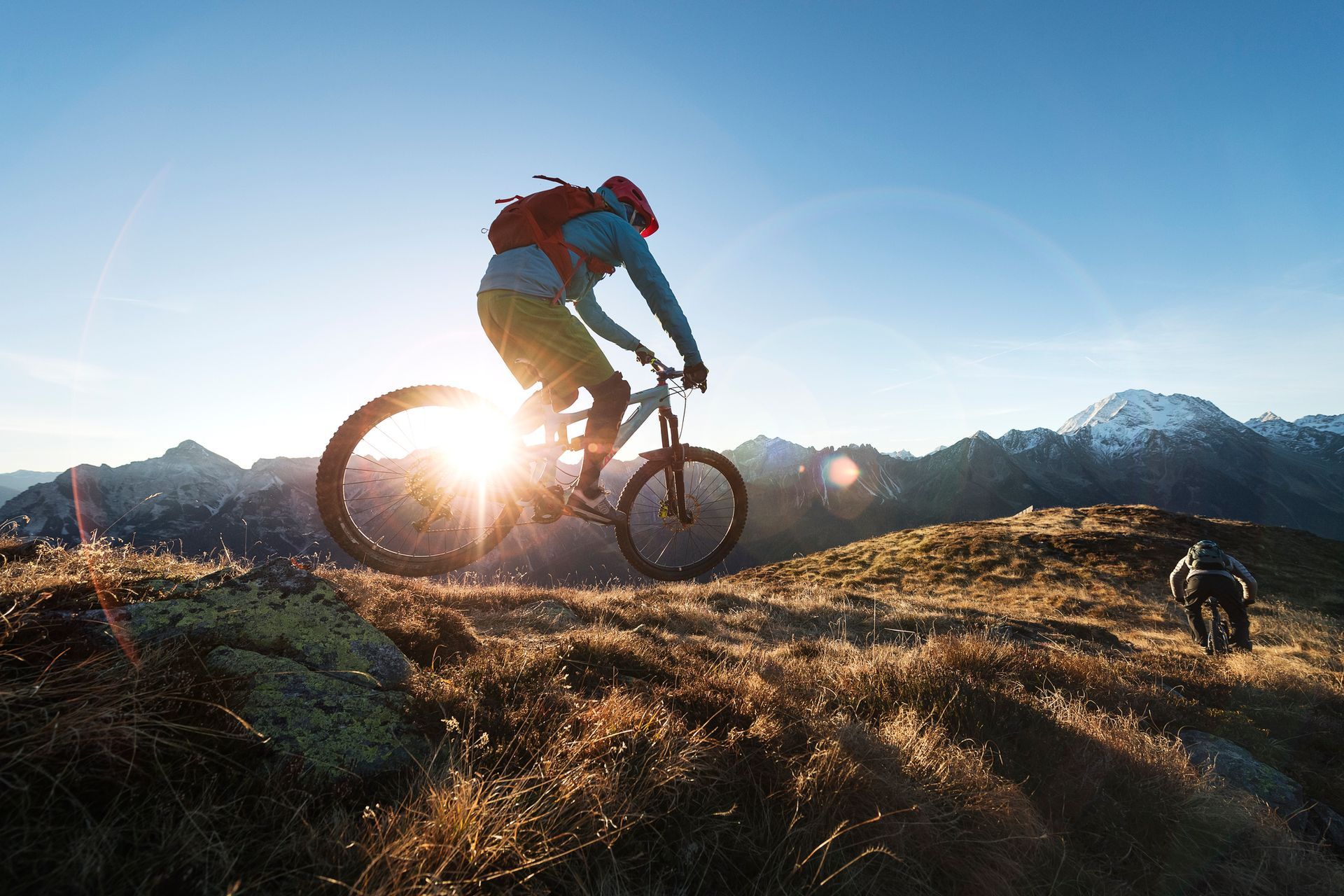 A shirtless man is lifting a dumbbell in a gym.