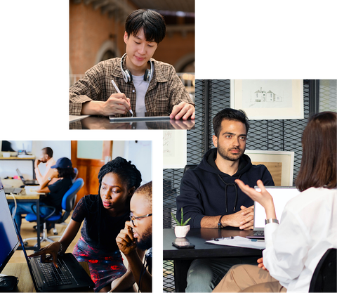 A group of people are sitting at a table with laptops.