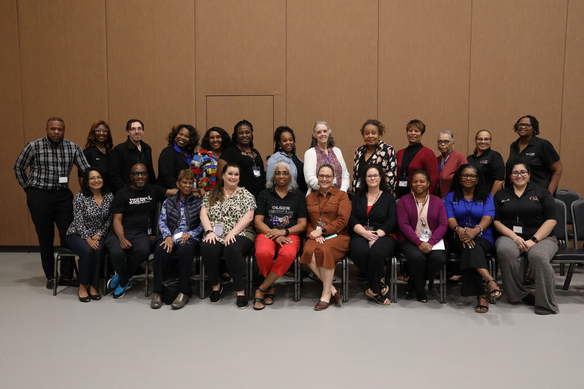 A large group of people are posing for a picture in a room.