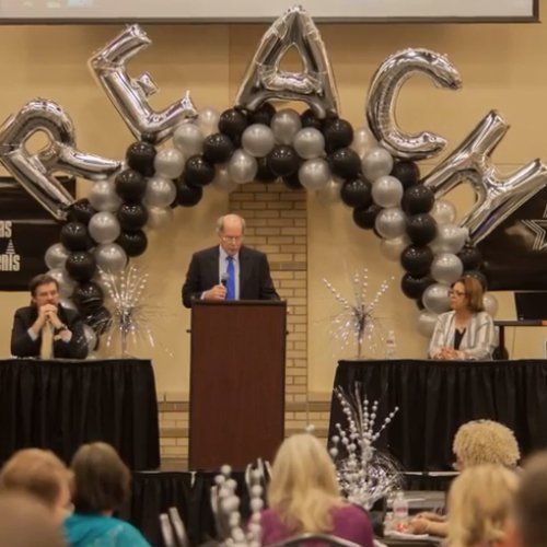 featured speaker at podium at REACH conference
