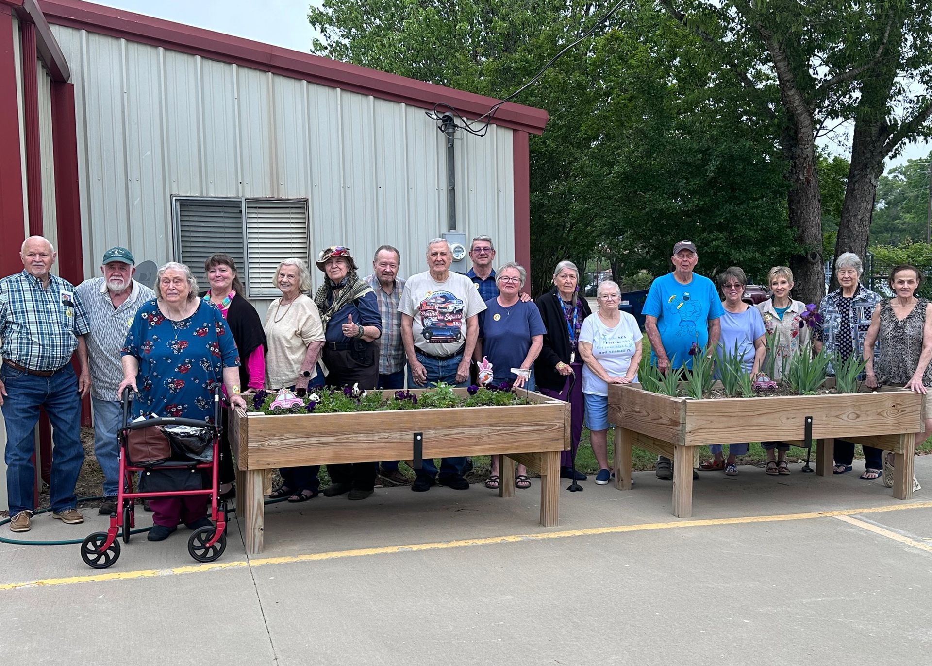 Group of seniors standing behind planer boxes