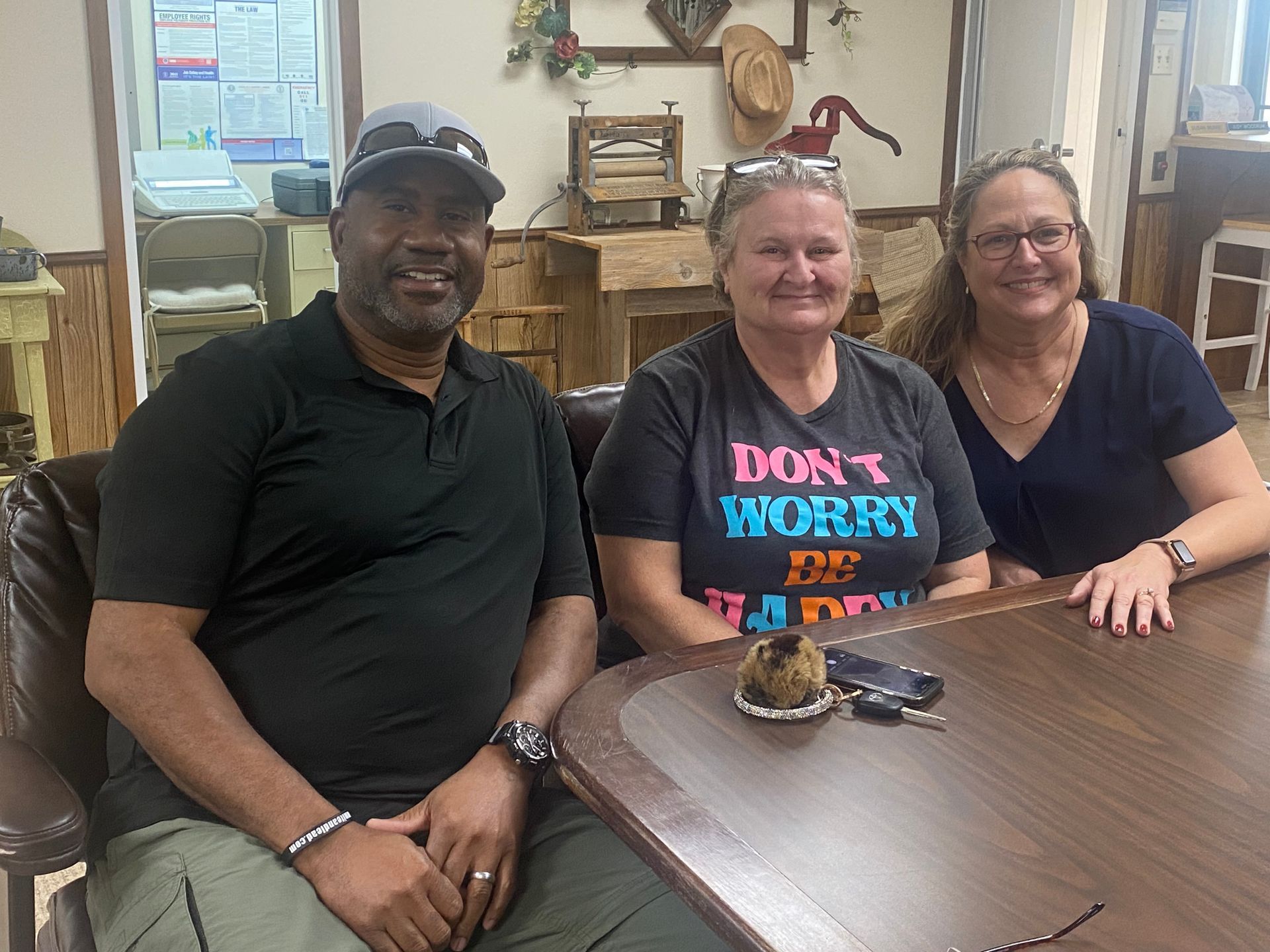A man and two women are sitting at a table in a restaurant.