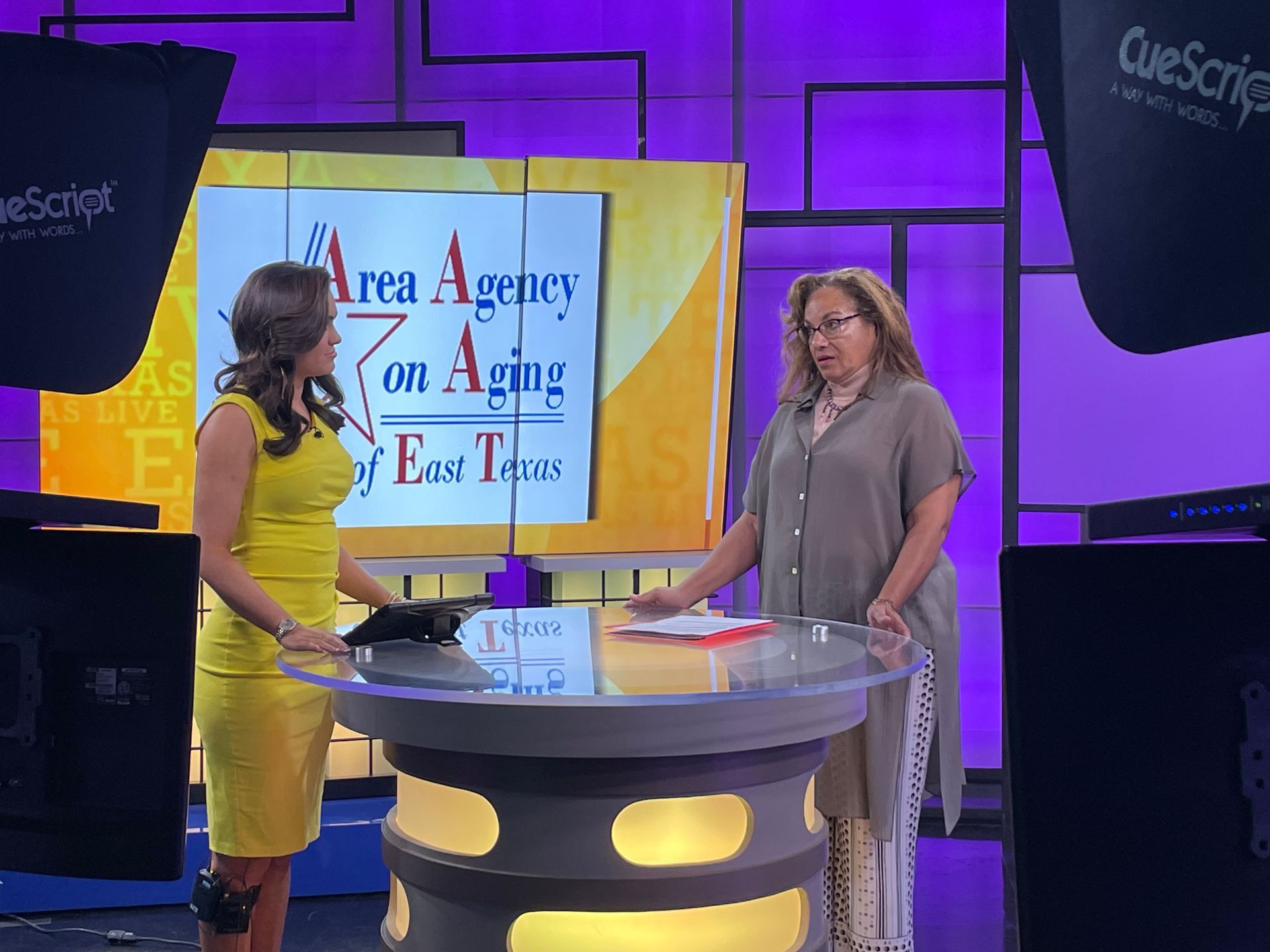 Two women in front of a screen that says area agency on aging