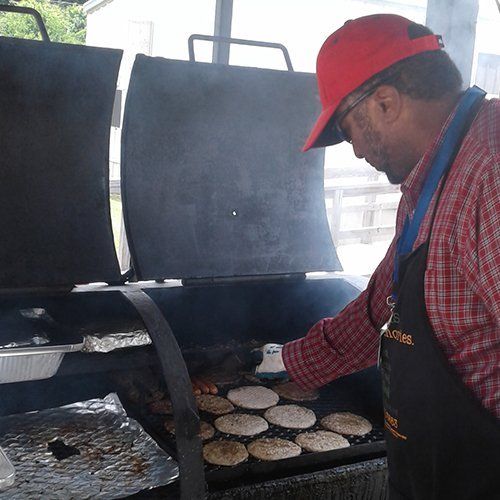 Staff member cooking for volunteers