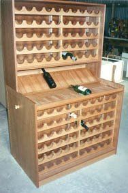 A wooden wine rack with two bottles of wine on top of it.