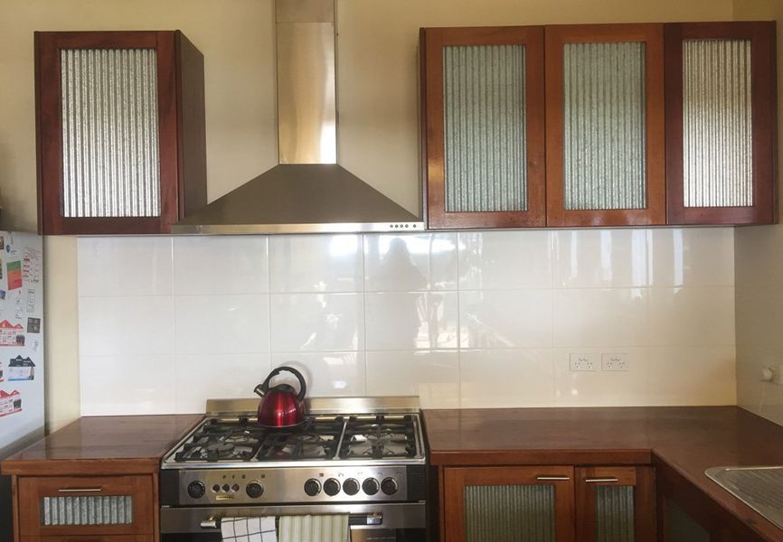 A kitchen with stainless steel appliances and wooden cabinets
