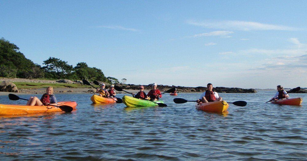 Group of people on the kayak while on a middle of Maine