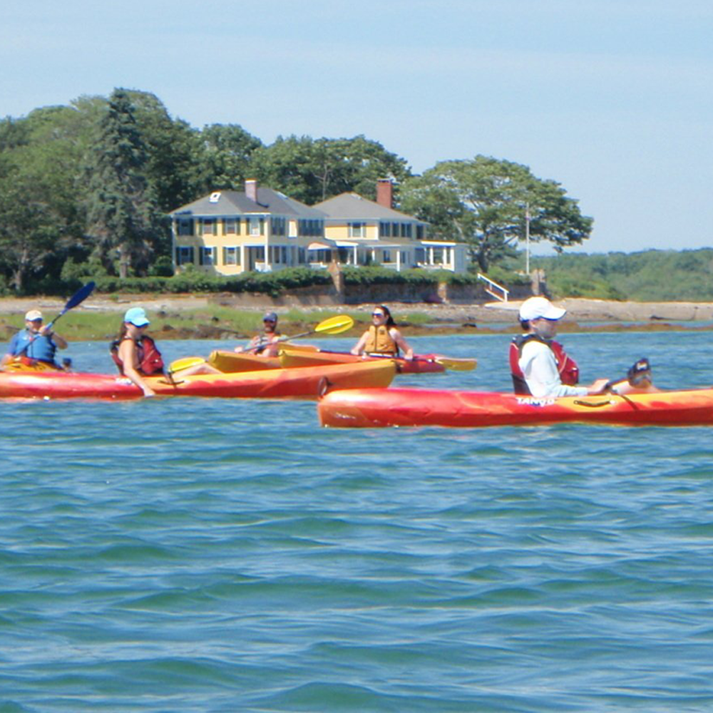 A woman on the kayak in the middle of the Maine