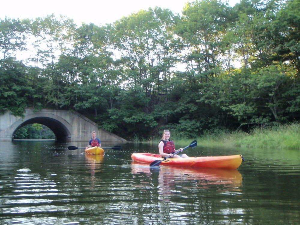 A woman on the kayak in the middle of the Maine