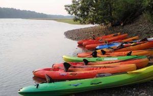 Kayaks on the shore of the Mousam River