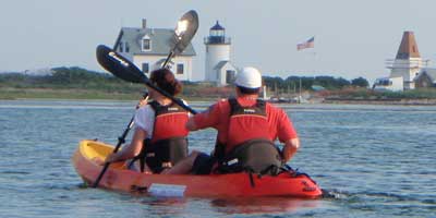 Man and woman on the middle of Maine while on tandem kayak