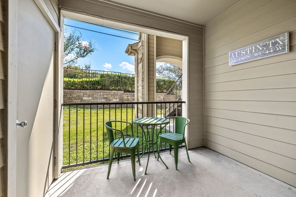 a balcony with a table and chairs on it at Marquis at Canyon Ridge in Austin, TX.
