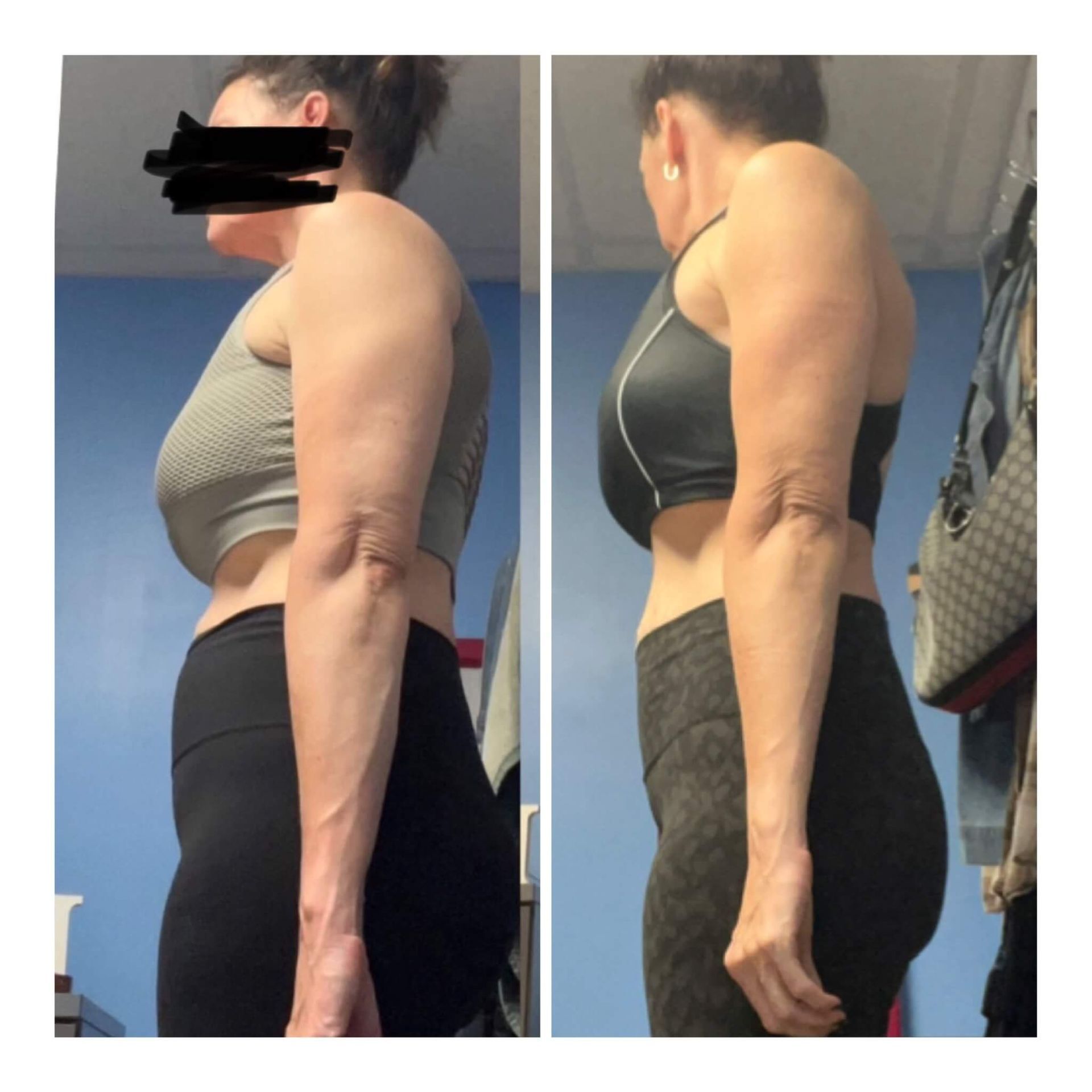 A woman is standing in front of a blue wall.