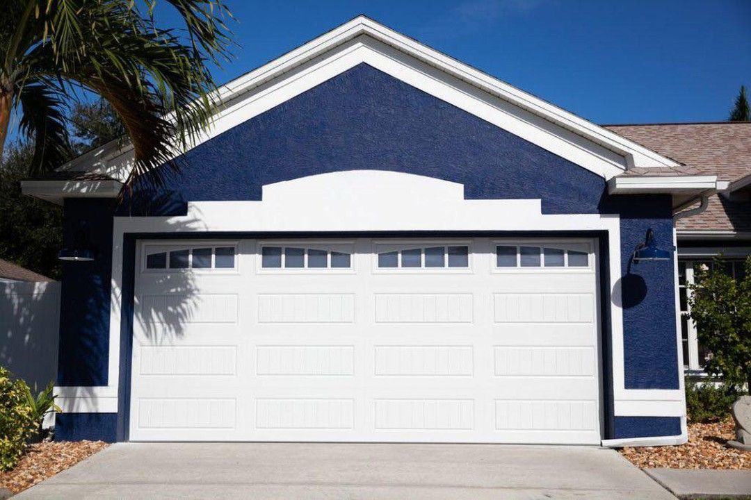 white garage door on a blue house