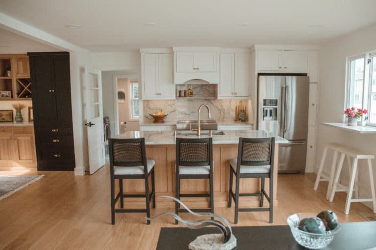 A kitchen with white cabinets and stainless steel appliances