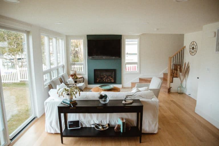 A living room with a couch , table , fireplace and television.