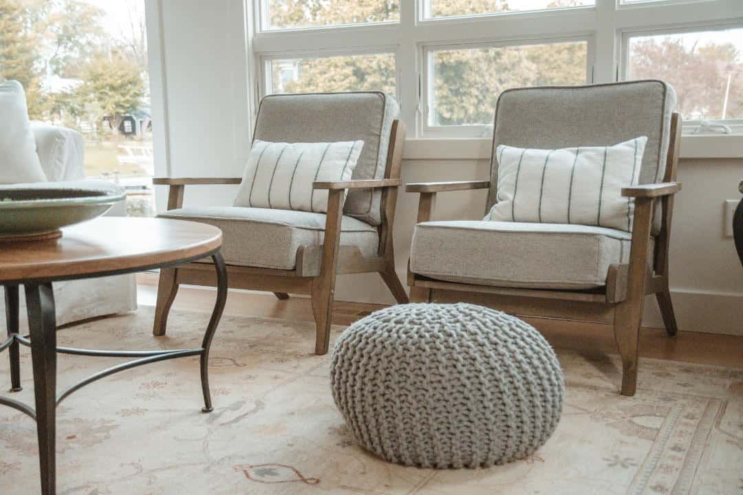 There are two chairs and a ottoman in the living room.