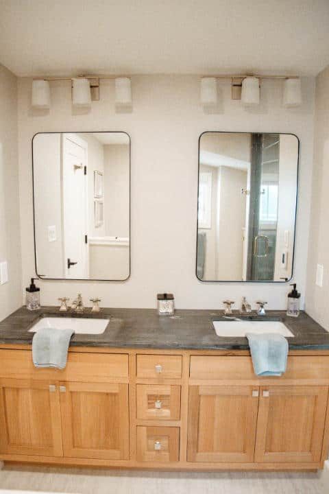 A bathroom with two sinks and two mirrors.