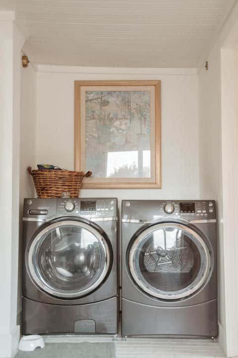 There are two washers and dryers in the laundry room.