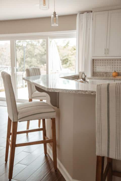 A kitchen with a table and chairs and a sliding glass door.