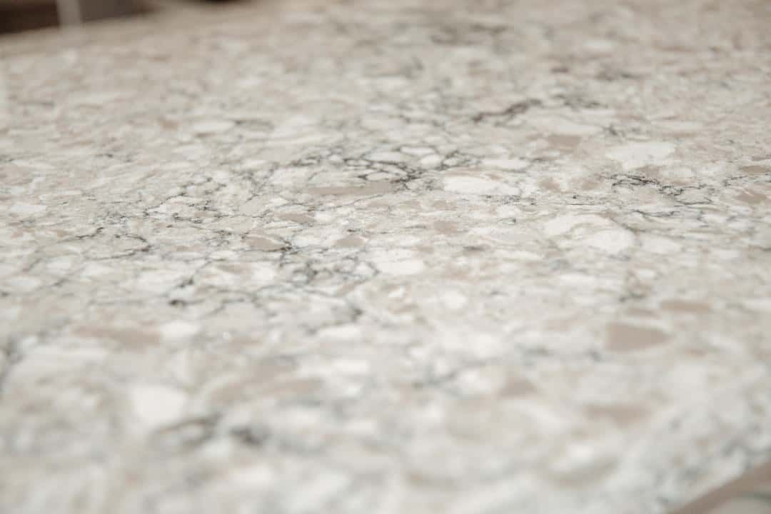 A close up of a marble counter top in a kitchen.