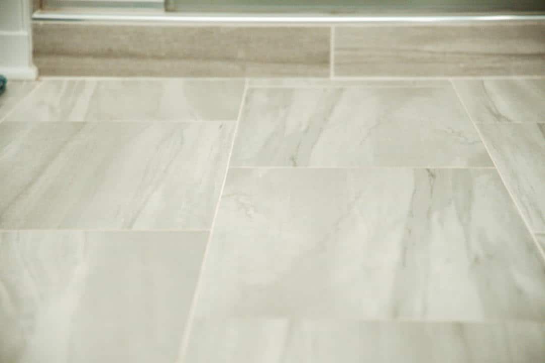 A close up of a tiled floor in a bathroom.