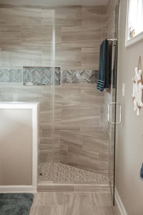 A bathroom with a walk in shower and a bathtub.