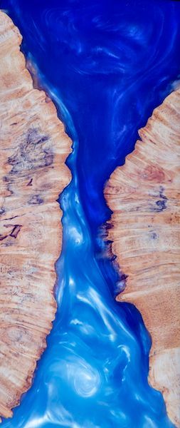 A close up of a river made of wood and blue resin.