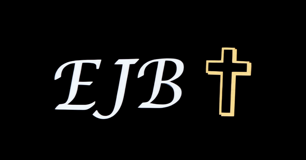 The initials EJB and a gold cross