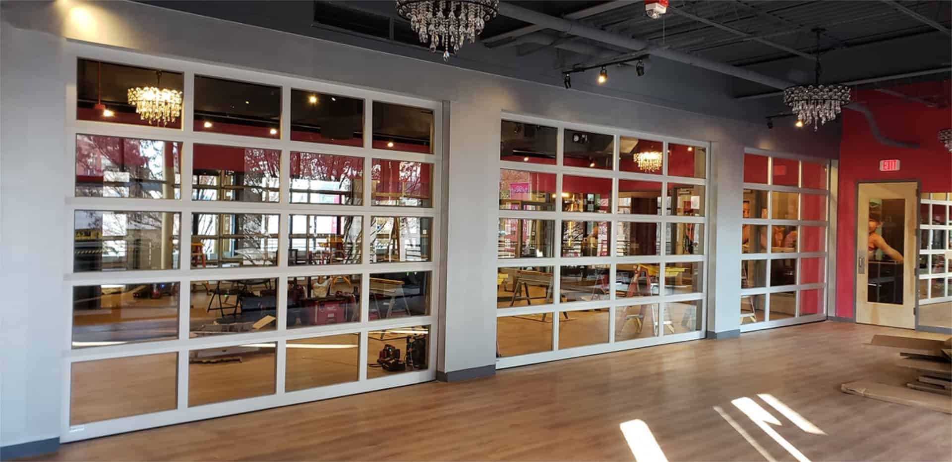 A large room with a lot of windows and a red wall.
