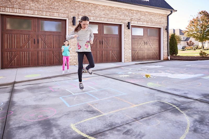 hopscotch in front of 3 garage doors 