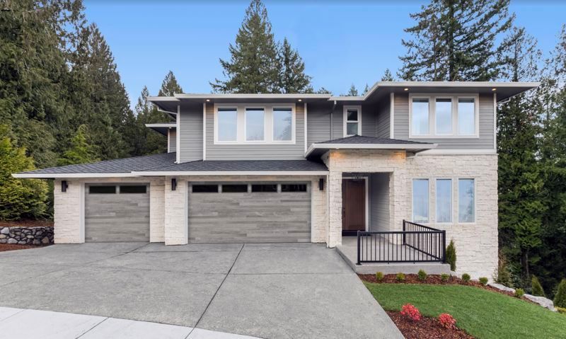 modern home with 2 large garage doors