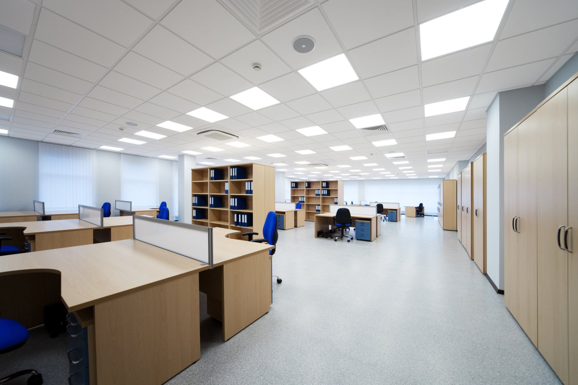 A large office with lots of desks and chairs