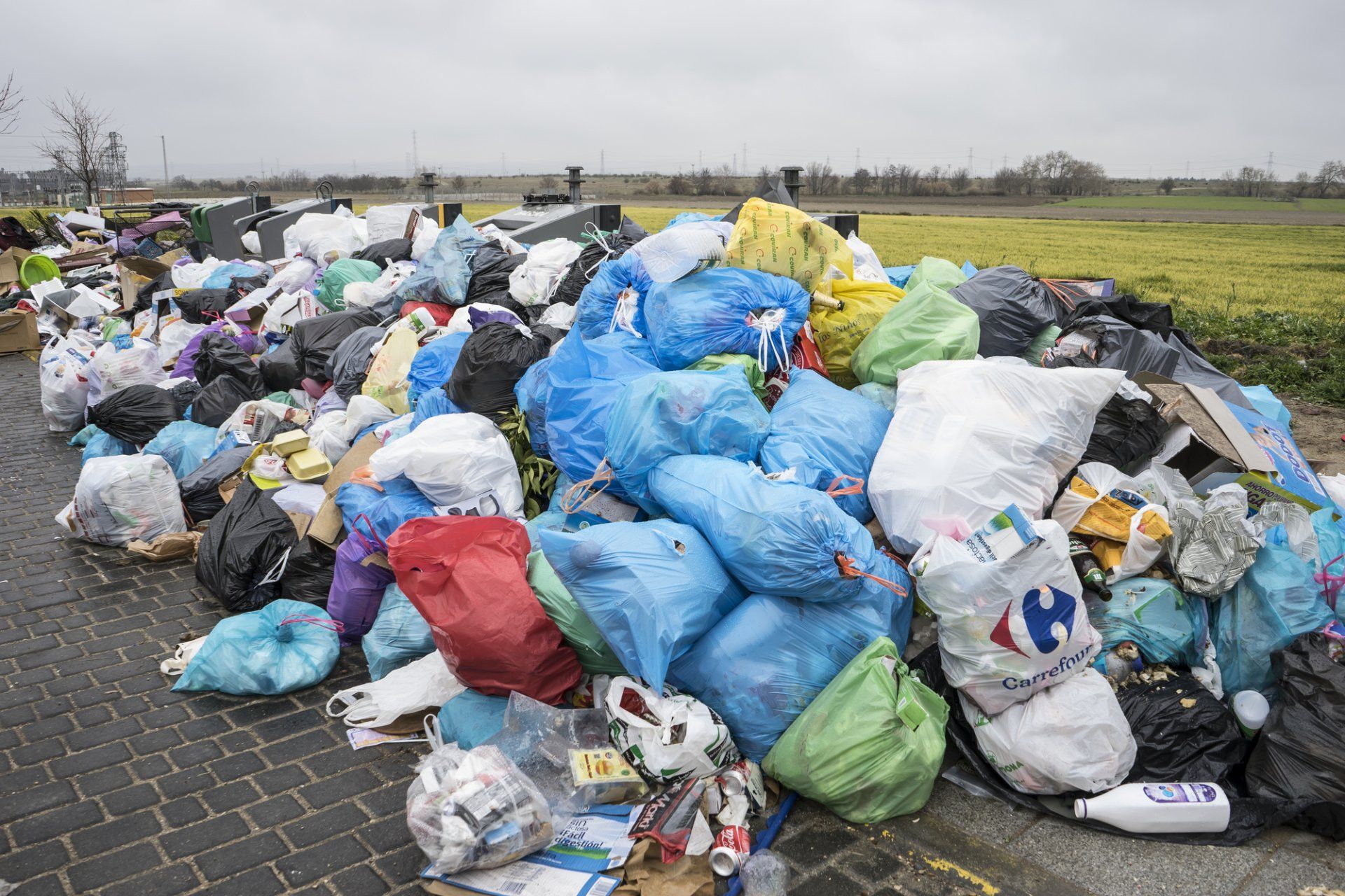 There is a large pile of trash on the side of the road.