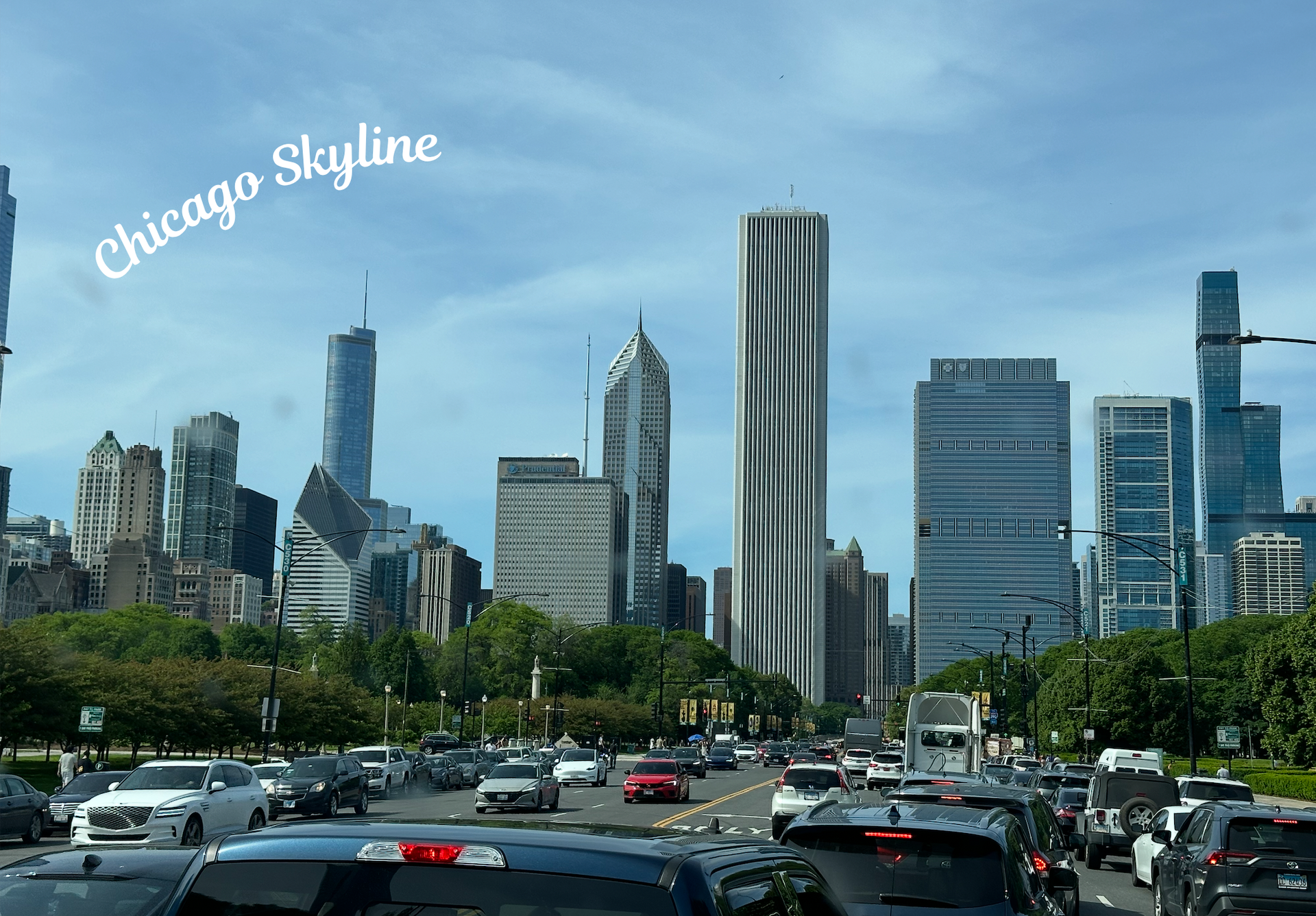 Black moving truck with green and blue accents;