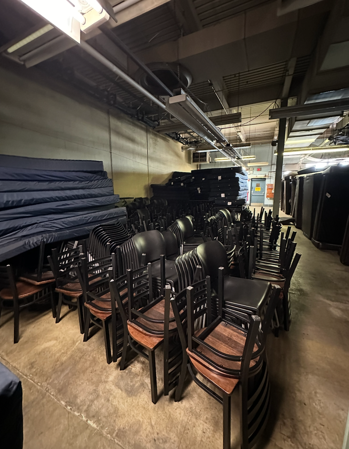 Boxes stacked inside a moving truck, full of items.