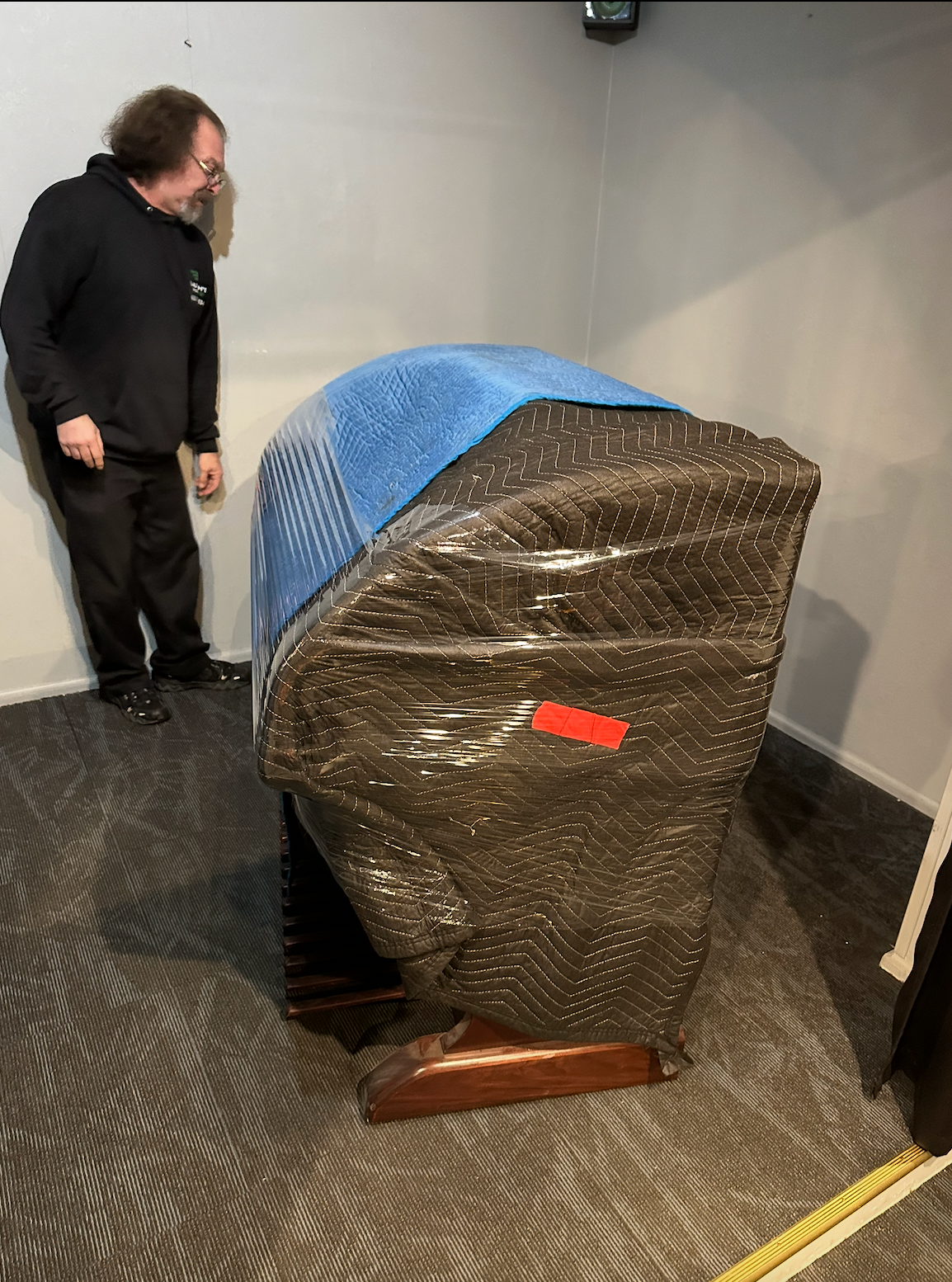 Black moving truck with green and blue accents; 