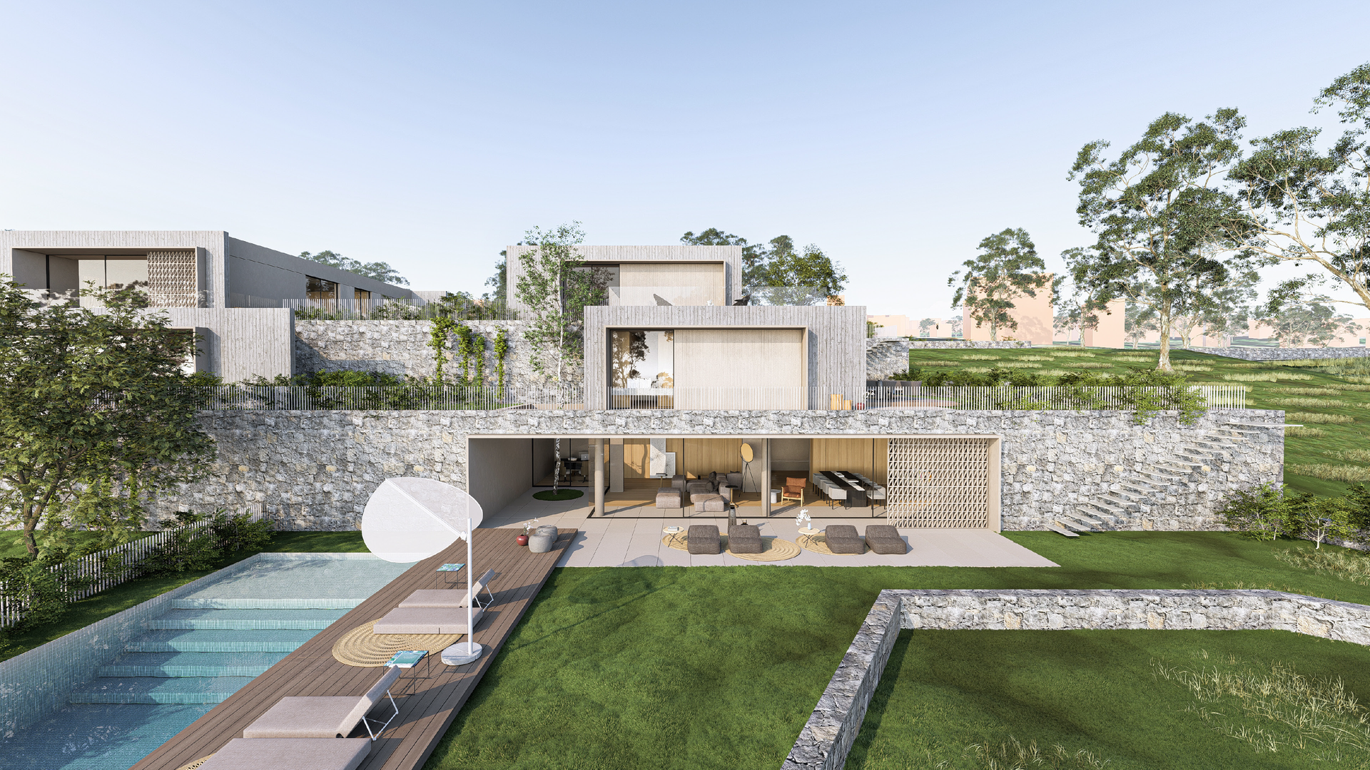 Moderna villa in pietra con piscina, prato e posti a sedere all'aperto.