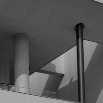 Schwarzweiß-Architekturfoto der Säulen und geometrischen Schatten eines Gebäudes.