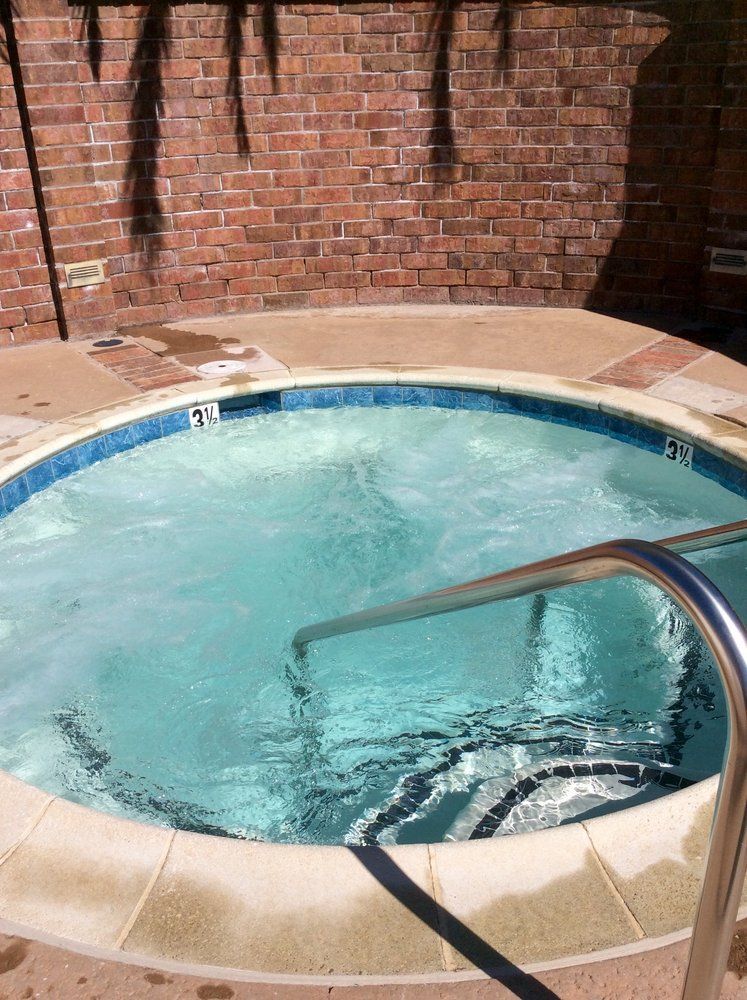 A hot tub with a brick wall in the background