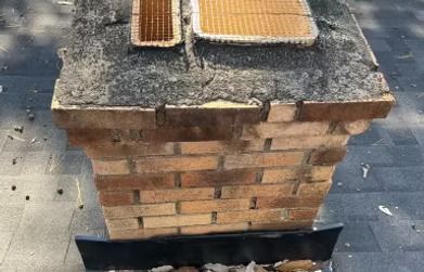 A brick chimney is sitting on top of a tiled floor. A brick chimney is sitting on top of a tiled floor.