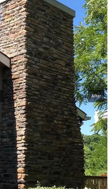 A large brick chimney is on the side of a house. A large brick chimney is on the side of a house.