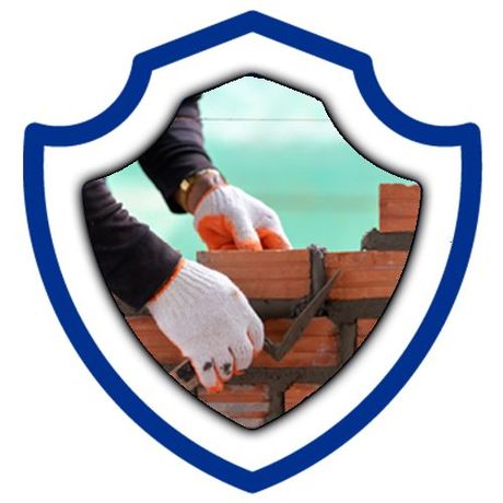 A person wearing gloves is working on a brick wall